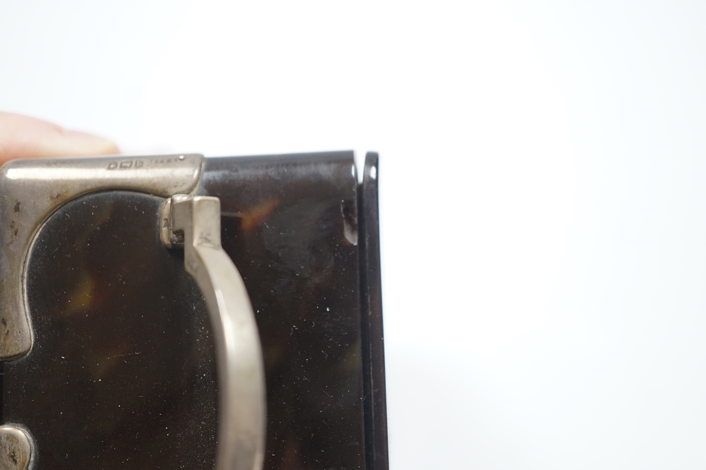 A George V silver mounted tortoiseshell cased carriage clock, with Arabic dial, chips to the case and ball foot missing, height 15cm over handle.